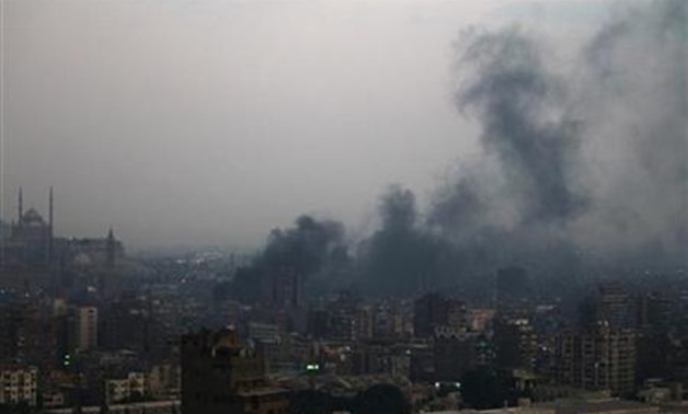 Smoke rises from burning garbage in downtown Cairo October 20, 2011. Environmentalists blame the burning of agricultural waste, mostly rice straw - Reuters