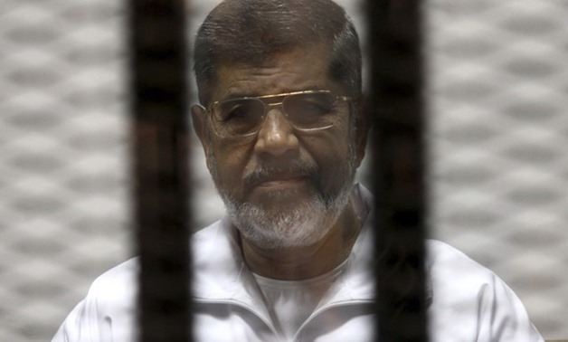 FILE - Morsi in a trial session