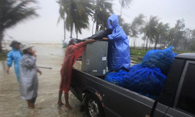 Locals clear out supplies from the coastline in preparation to the approaching Tropical Storm Pabuk on Friday, January 4. (AP)
