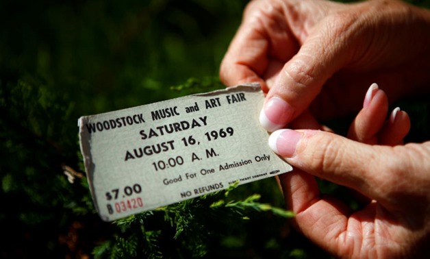 FILE PHOTO: Janet Huey displays her original ticket at the site of the original Woodstock Music Festival in Bethel, New York, U.S. August 14, 2009. REUTERS/Eric Thayer