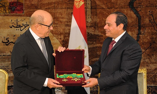 President Abdel Fatah al-Sisi (R) grants French Minister of Defense Jean-Yves Le Drian Order of the Republic - Press photo