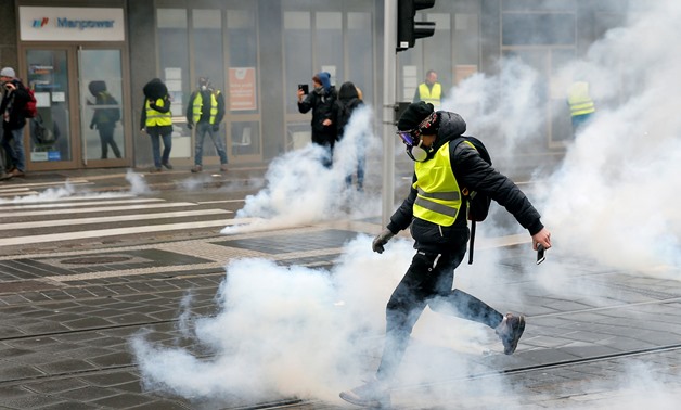 FILE PHOTO: A protester returns a tear gas canister during a demonstration of the "yellow vests" movement in Strasbourg, France, January 12, 2019. REUTERS/Vincent Kessler/File Photo
