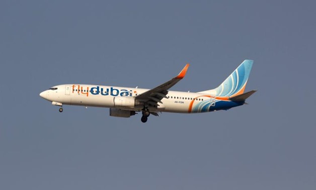 FILE PHOTO: A Flydubai airplane is pictured in the sky over Dubai, United Arab Emirates. Reuters