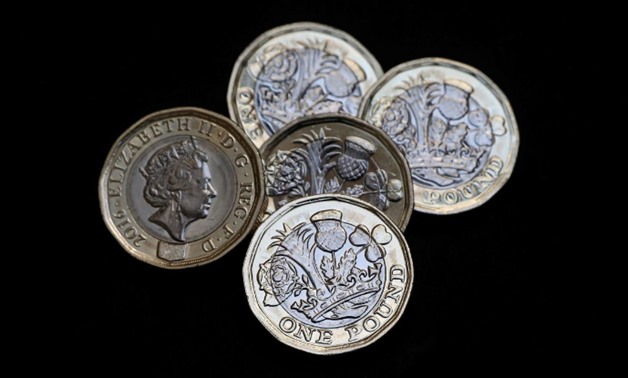 FILE PHOTO: New one pound coins, which come into circulation today, are seen in London, Britain March 28, 2017. REUTERS/Neil Hall
