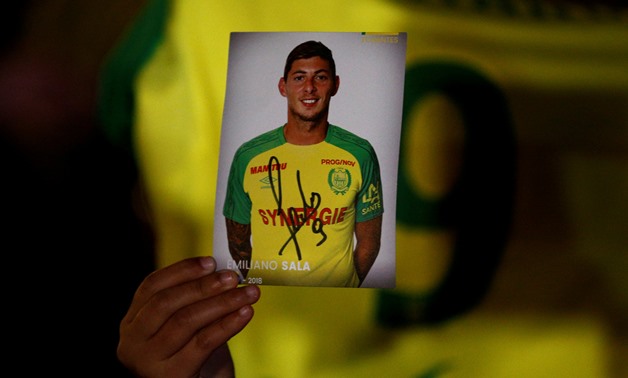 REFILE - ADDING RESTRICTIONS A fan holds a portrait of Emiliano Sala in Nantes' city center after news that newly-signed Cardiff City soccer player Emiliano Sala was missing after the light aircraft he was travelling in disappeared between France and Engl