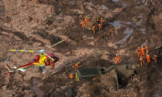 Brazil rescuers search for hundreds missing after mining dam burst | Reuters
