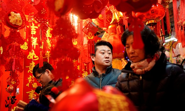 People shop for Chinese Lunar New Year decorations in Yu Yuan Garden in Shanghai, China January 31, 2019. REUTERS/Aly Song
