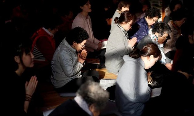 FILE PHOTO: Parents pray for their children's success in the college entrance examinations at a Buddhist temple in Seoul, South Korea, November 15, 2018. REUTERS/Kim Hong-Ji/File Photo.