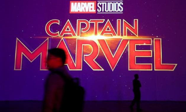 A man is silhouetted against the Captain Marvel logo at a fan event in Singapore, February 14, 2019. REUTERS/Feline Lim.