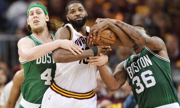 Cleveland Cavaliers center Tristan Thompson (13) fights for possession with Boston Celtics center Kelly Olynyk (41) and guard Marcus Smart (36) during the first half in game three of the Eastern conference finals of the NBA Playoffs at Quicken Loans Arena