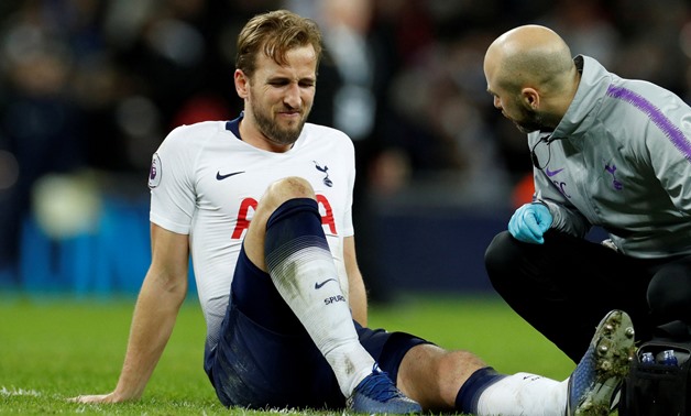 FILE PHOTO: Soccer Football - Premier League - Tottenham Hotspur v Manchester United - Wembley Stadium, London, Britain - January 13, 2019 Tottenham's Harry Kane reacts as he receives treatment from the physio after sustaining an injury at the end of the 