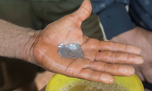An artisanal miner shows a piece of mercury that has coagulated with tiny particles of gold at a mill in El Callao, Venezuela August 8, 2018. William Urdaneta, Reuters