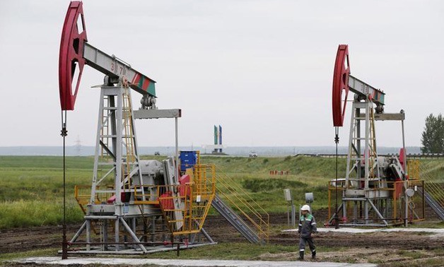 Pump jacks pump oil at an oil field Buzovyazovskoye owned by Bashneft company north - REUTERS/Sergei Karpukhin