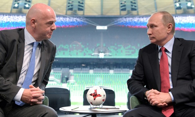 President Vladimir Putin (R) with Gianni Infantino (L) - AFP