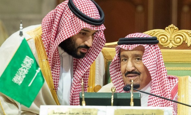 Saudi Arabia's Crown Prince Mohammed bin Salman talks with Saudi Arabia's King Salman bin Abdulaziz Al Saud during the Gulf Cooperation Council's (GCC) Summit in Riyadh, Saudi Arabia Dec. 9, 2018. Bandar Algaloud/Courtesy of Saudi Royal Court/Handout via 