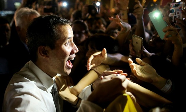 Agustin Marcarian, Reuters | Venezuelan opposition leader Juan Guaido, who many nations have recognized as the country's rightful interim ruler, gestures to Venezuelan citizens in Buenos Aires, Argentina, March 1, 2019.