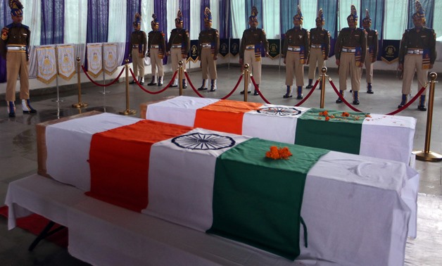 India's Central Reserve Police Force (CRPF) personnel stand behind the coffins of their two colleagues, who according to police were killed during a gun battle with militants in north Kashmir's Kupwara district on Friday, during a wreath-laying ceremony o