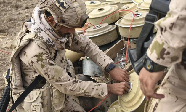 FILE: An Emirati soldiers threads detonator cord through a captured Houthi landmine. Credit: The National

