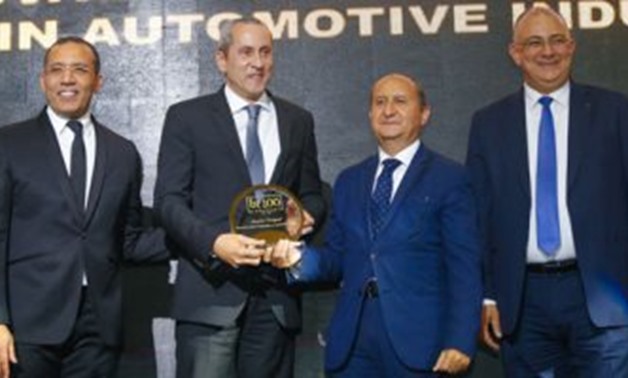 Khaled Youssef, CEO of Mansco – Official Sole dealer Peugeot Egypt, receiving the bt 100 crystal award.
