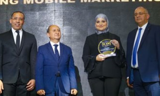 Engy AlSaban, CEO of VictoryLink, receiving the bt100 crystal award