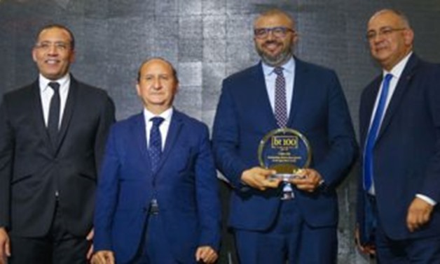Ayman Gamil, Owner & Chairman Cairo 3A, receiving the bt100 crystal award.