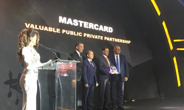 Khalid Algibali, Division President, Middle East and North Africa of Mastercard, receiving the bt100 crystal award 
