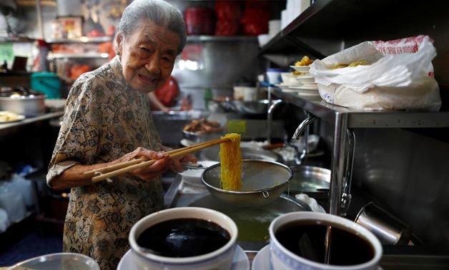 Hawker Leong Yuet Meng, 90, of Nam Seng Noodle House, poses as she cooks noodles at her shop in Singapore February 22, 2019. Picture taken February 22, 2019. REUTERS/Edgar Su
