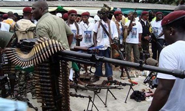 Nigerian militant youths display weapons surrendered by former militants at an arms collection centre at Tourist beach in the oil hub Port Harcourt, October 3, 2009 - REUTERS
