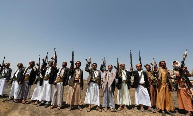 Tribesmen loyal to the Houthi movement hold up their rifles as they shout slogans during a pro-Houthi tribal gathering in a rural area near Sanaa. (File photo: Reuters)