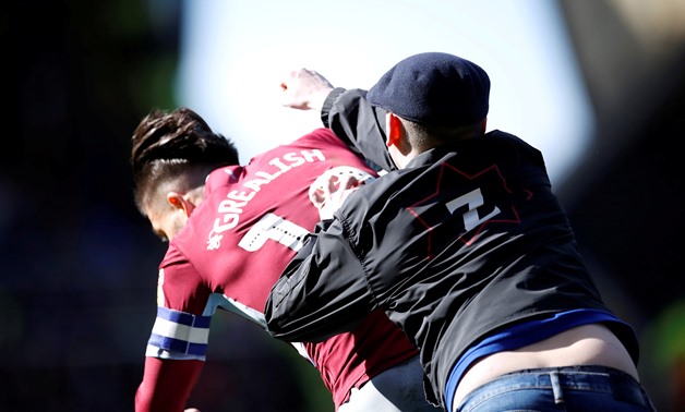 Birmingham City v Aston Villa - St Andrew's, Birmingham, Britain - March 10, 2019 A fan invades the pitch and attacks Aston Villa's Jack Grealish during the match Action Images via Reuters/Carl Recine