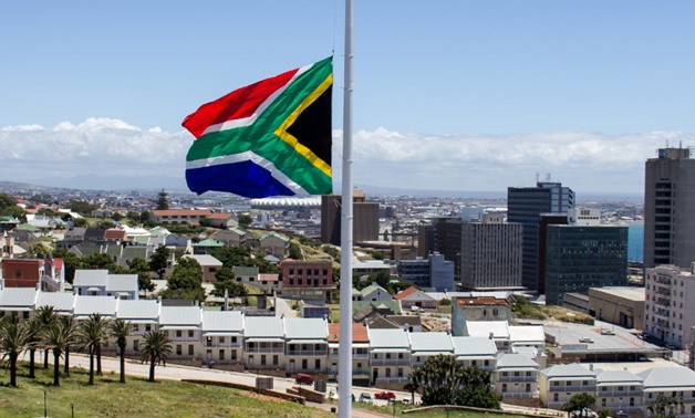 The South African Flag flying on half mast outside the Donkin Reserve in Port Elizabeth during the national mourning period for Nelson Mandela. It is said to be the tallest flagpole in Africa, and the largest South African flag in the world – Wikimedia Co