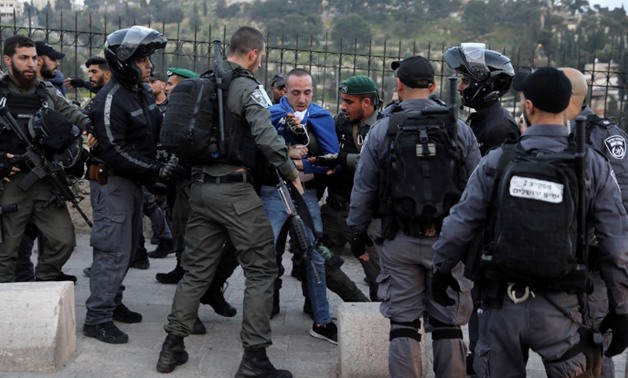 Israeli police officers detain a Palestinian protestor during scuffles outside the compound housing al-Aqsa Mosque in Jerusalem's Old City March 12, 2019. REUTERS/Ammar Awad
