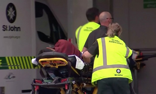 Video grab of emergency services personnel push stretchers carrying a person into a hospital, after reports that several shots had been fired, in central Christchurch