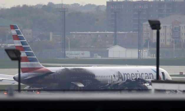 Soot covers the fuselage of an American Airlines jet that blew a tire, sparking a fire and prompting the pilot to abort takeoff before passengers were evacuated from the plane via emergency chute, at O'Hare International Airport in Chicago, Illinois, U.S.