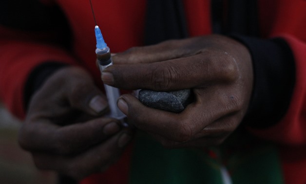 File - African man holding a syringe - Reuters/Soe Zeya Tun