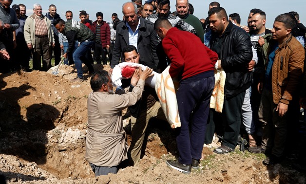 Mourners carry one of the victims who died after an overloaded ferry sank in Tigris river near Mosul, during his funeral at Mosul cemetery, Iraq March 22, 2019. REUTERS/Khalid al-Mousily