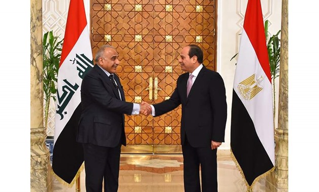 PRESS: (R) Egyptian President Abdel Fatah al-Sisi shaking hands with (L) Iraqi Prime Minister Adil Abdul Mahdi