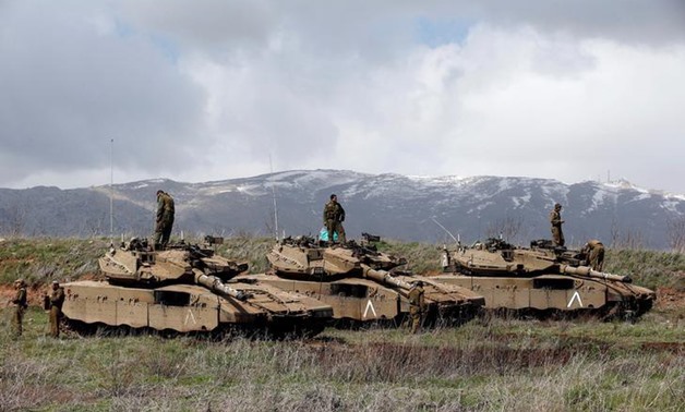FILE PHOTO: Israeli soldiers stand atop tanks in the Golan Heights near Israel's border with Syria March 19, 2014. REUTERS/Ronen Zvulun/File Photo

