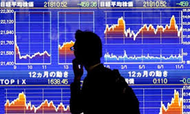 FILE PHOTO: A man looks at an electronic stock quotation board showing Japan's Nikkei average outside a brokerage in Tokyo, Japan, November 13, 2018. REUTERS/Toru Hanai
