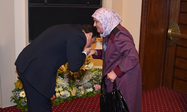 President Abdel Fatah al-Sisi kisses hand of an ideal mother on the Egyptian Woman Day
