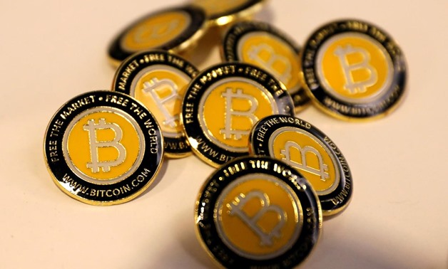 FILE PHOTO: Bitcoin.com buttons are seen displayed on the floor of the Consensus 2018 blockchain technology conference in New York City, New York, U.S., May 16, 2018. REUTERS/Mike Segar/File Photo
