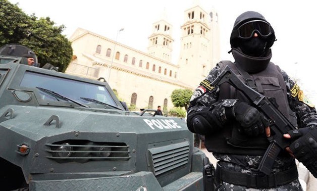A special forces police officer stand guard to secure the area around Saint Mark's coptic Orthodox Cathedral before a Coptic Christmas mass in Cairo - Reuters