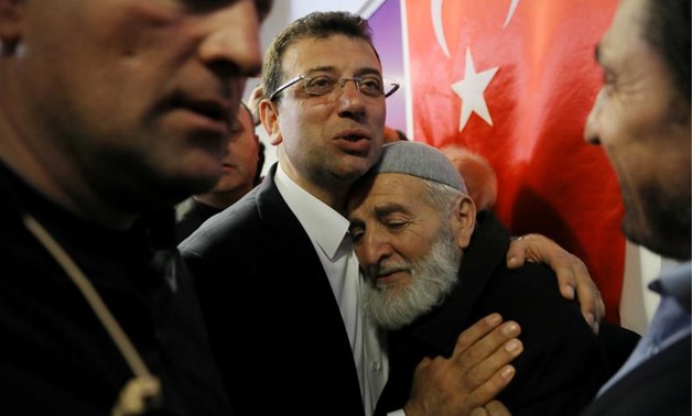 FILE PHOTO: Ekrem Imamoglu, main opposition Republican People's Party (CHP) candidate for mayor of Istanbul, embraces his supporter at his election campaign office in Istanbul, Turkey April 1, 2019. REUTERS/Huseyin Aldemir/File Photo
