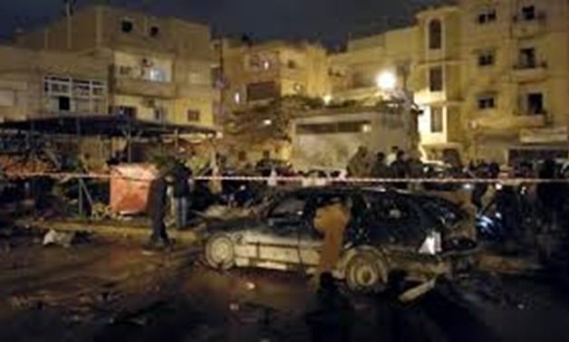 People gather in the aftermath of twin car bombs late Tuesday in Benghazi, Libya. (Reuters)
