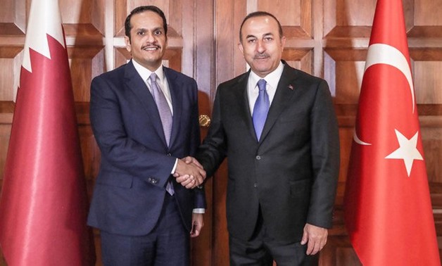 Turkey's minister for Foreign Affairs Mevlut Cavusoglu (R) shaking hands with Qatari Deputy Prime Minister and minister for Foreign Affairs Mohammed bin Abdulrahman Al-Thani. (AFP)