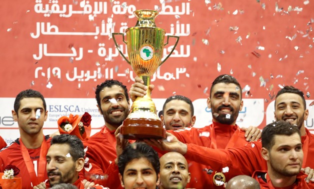 Volleyball - Men’s African Volleyball Club Championship - Final - Al Ahly v Smouha - Al Ahly Club Staduim- Cairo, Egypt - April 10, 2019 - Egypt’s Al Ahly players celebrate with the trophy after winning the final against Egypt's Smouha. REUTERS/Amr Abdall
