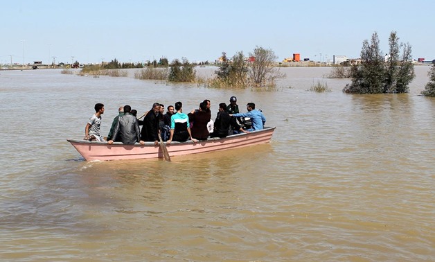 FILE PHOTO: People are seen on a boat after a flooding in Golestan province, Iran, March 24, 2019. Tasnim News Agency/via REUTERS
