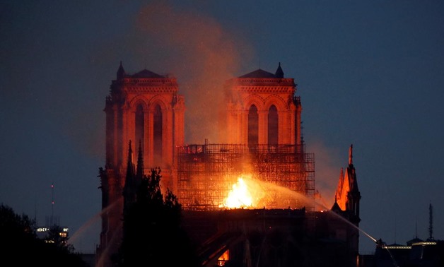 Fire fighters douse flames of the burning Notre Dame Cathedral in Paris, France April 15, 2019. REUTERS/Charles Platiau
