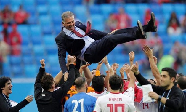 Iran players hoist Carlos Queiroz into the air as they celebrate beating Morocco in their opening game of the 2018 Russia World Cup. (Reuters)
