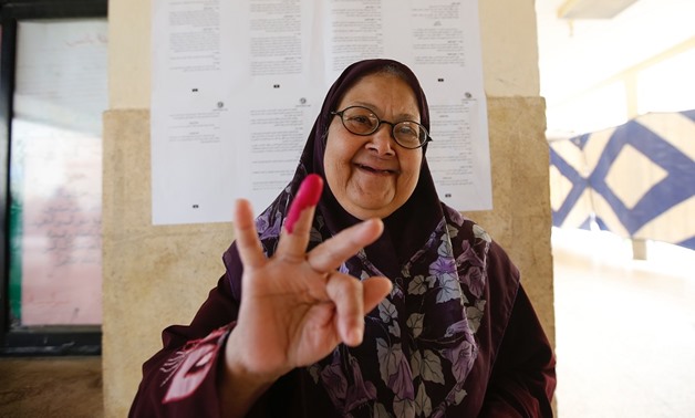 Woman voter shows her inked finger after casting her vote in referendum in 6 of October city - Mohamed el-Hosary/Egypt Today